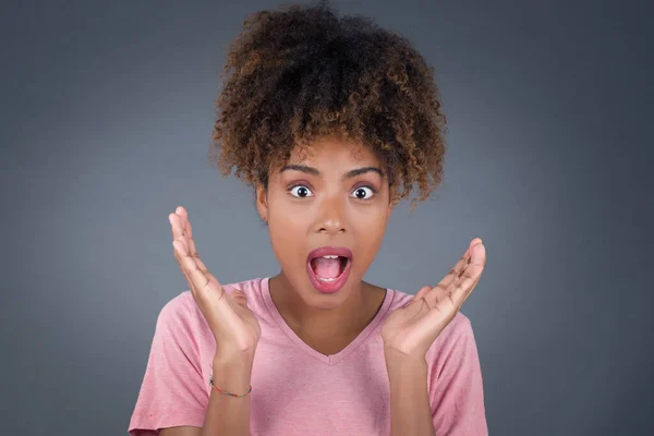 Surprise concept. Portrait of astonished beautiful girl looking surprised in full disbelief wide open mouth with hands near face with braided hair. Positive emotion facial expression body language.