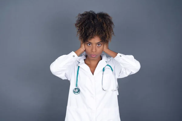 African American Doctor Woman Wearing Medical Uniform Plugging Ears Hands — Stock Photo, Image