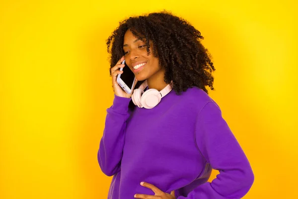 Donna Afroamericana Sfondo Giallo Che Parla Telefono Sorride Emozioni Gesti — Foto Stock