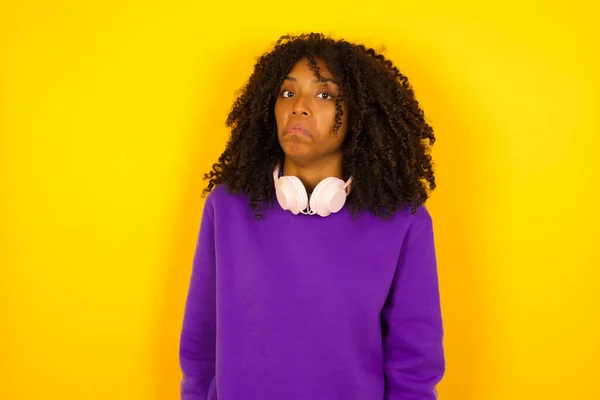 African American Female Looks Unsure Yellow Background Emotions Gestures Concept — Stock Photo, Image