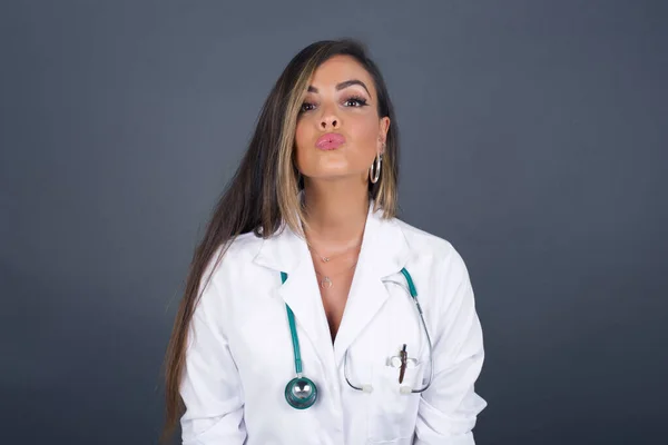 Pleasant Looking Young Doctor Woman Wearing Medical Uniform Keeps Lips — Stock Photo, Image