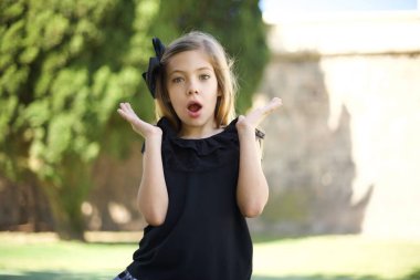 Sürpriz konsept. Şaşırmış güzel bir kızın portresi. İnanamamasına şaşırmış gibi görünüyor. Ağzın sonuna kadar açık, elin yüzüne yakın, saçların örgülü. Olumlu duygu yüz ifadesi vücut dili.