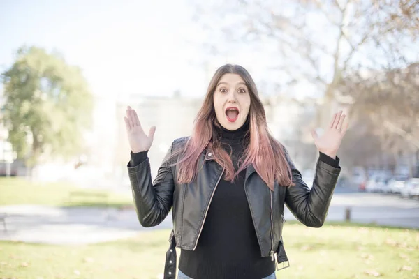 young beautiful woman   is surprised  in the park