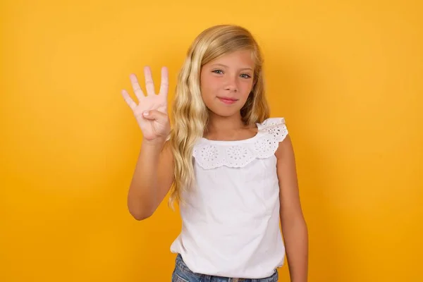 Cute Young Blonde Little Girl Yellow Studio Background Showing Four — Stock Photo, Image