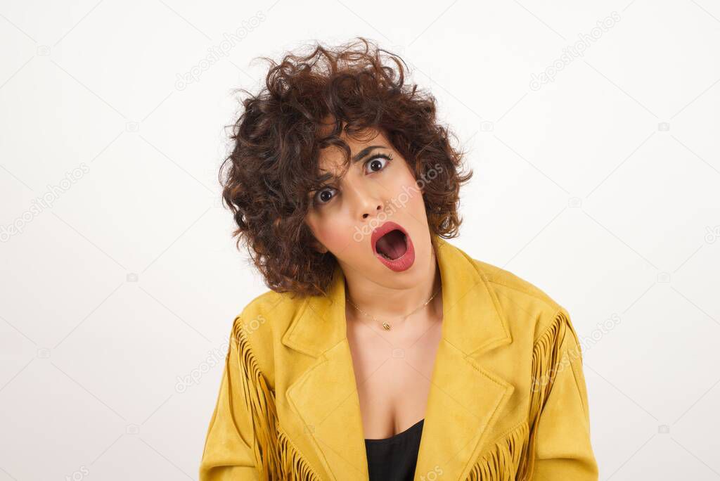 Beautiful  woman in suede jacket  with wide open mouth  studio shot