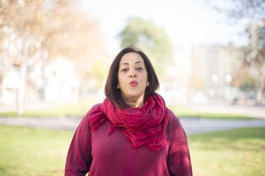 Güzel orta yaşlı Arap kadın parkta öpüşüyor.  