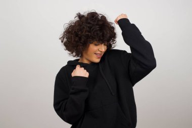 Güzel bir kadın. Mutlu ve heyecanlı. Kazanan bir jest. Başarılı ve zaferi kutlayan, muzaffer.