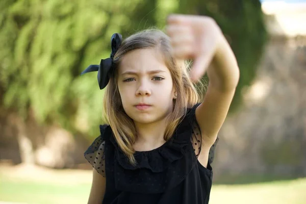 Discontent Girl Shows Disapproval Sign Keeps Thumb Expresses Dislike Frowns — Stock Photo, Image