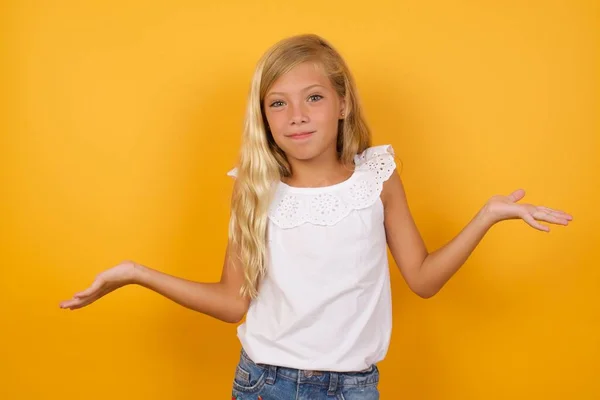Cute Young Blonde Little Girl Yellow Studio Background Confused — Stock Photo, Image