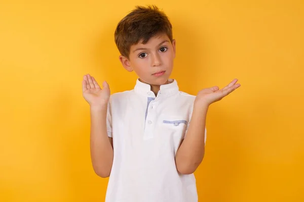 Cute Boy Showing Something Yellow Wall — Stock Photo, Image