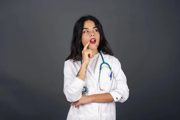 Dreamy Doctor Thoughtful Expression Looks Camera Keeps Hand Face Bitting — Stock Photo, Image