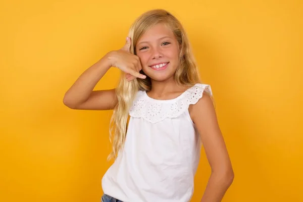 Cute Little Girl Pink Dress Yellow Studio Background Call Gesture — Stock Photo, Image