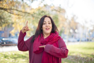 Güzel orta yaşlı Arap kadın parkı işaret ediyor.  
