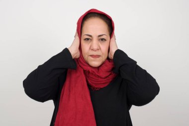Elleriyle kulaklarını tıkayan olgun Müslüman kadın hard rock veya yüksek sesle müzik dinlemek istemiyor.. 