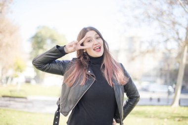 Parkta el kol hareketi yapan güzel bir kadın.