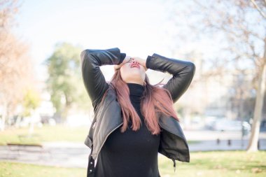 Parkta yüzü olan genç ve güzel bir kadın.