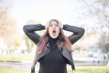 Genç ve güzel bir kadın parkta bağırıyor.