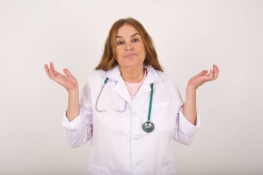 Kafası karışmış, kafası karışık, beyaz doktor kadın kollarını açmış, omuzlarını silkip, 