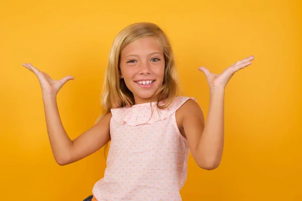 Cute Little Girl Pink Dress Yellow Studio Background Showing Palms — Stock Photo, Image