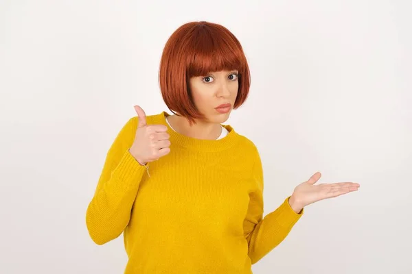 Young Happy Cheerful Woman Showing Thumb Pointing Other Hand While — Stock Photo, Image