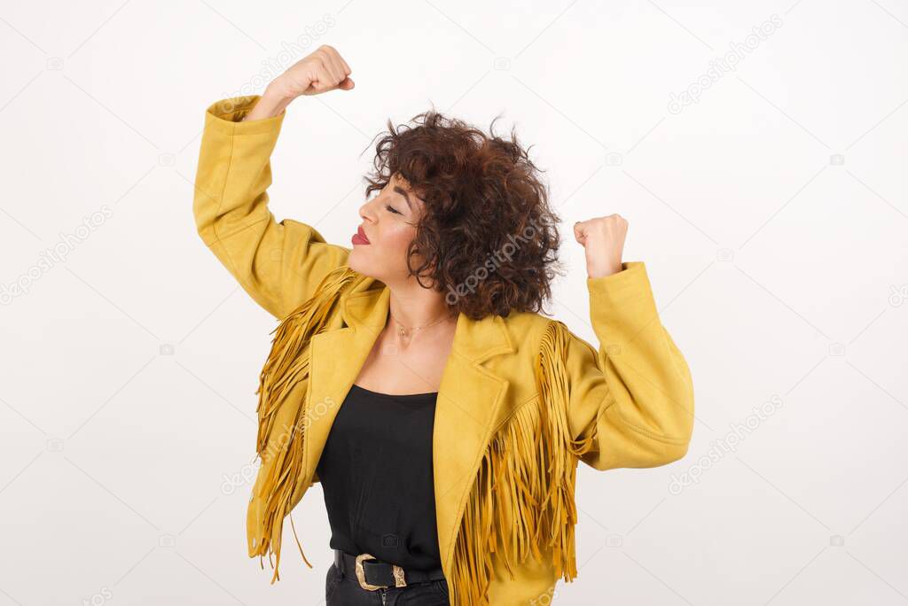 Yes I am winner. Portrait of charming delighted and excited caucasian female student raising up fists in triumph and victory smiling achieving success grinning from delight.