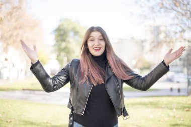 Genç ve güzel bir kadın parkta mutlu.