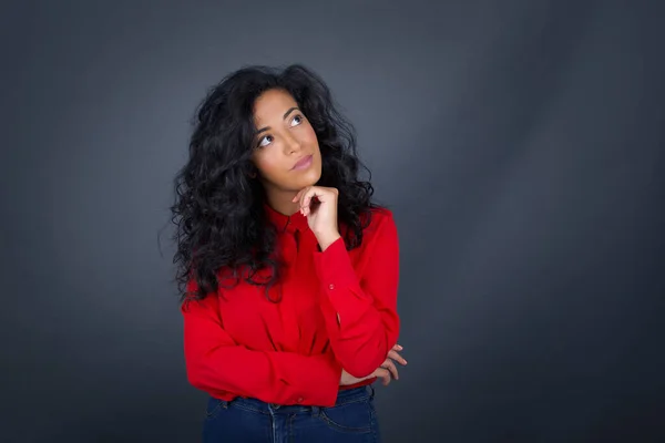 Thoughtful Young Brunette Woman Curly Hair Wearing Red Shirt Holding — Stock Photo, Image