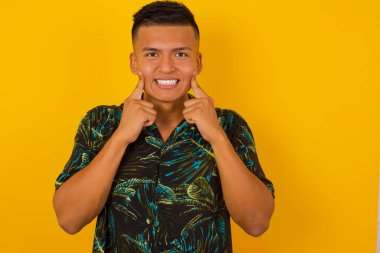 Güçlü, sağlıklı, beyaz dişlere sahip olma kavramı. Arka planda izole edilmiş kusursuz beyaz dişlerini gösteren ışıl ışıl gülümseyen mutlu İspanyol adamın yakın portresi..