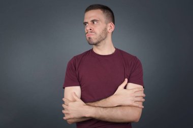 Closeup portrait displeased pissed off angry grumpy pessimistic man with bad attitude, arms crossed looking sideways. Negative human emotion facial expression feelings