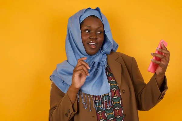 배경에 전화를 성공을 아프리카계 무슬림 여성의 초상화 — 스톡 사진