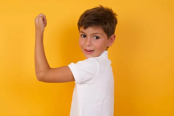 Cute Boy Showing Muscle Yellow Wall — Stock Photo, Image