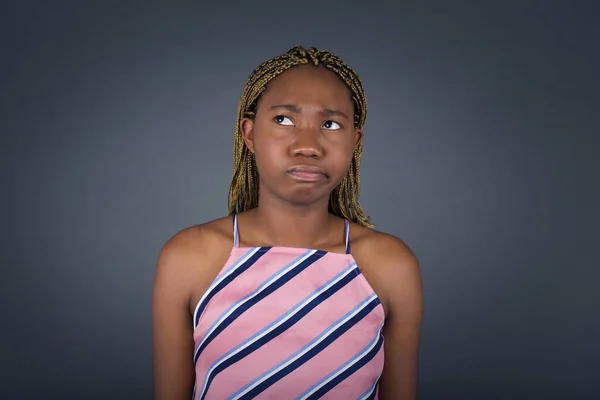 Puzzled Young African American Woman Frowns Face Bites Lip Raises — Stock Photo, Image