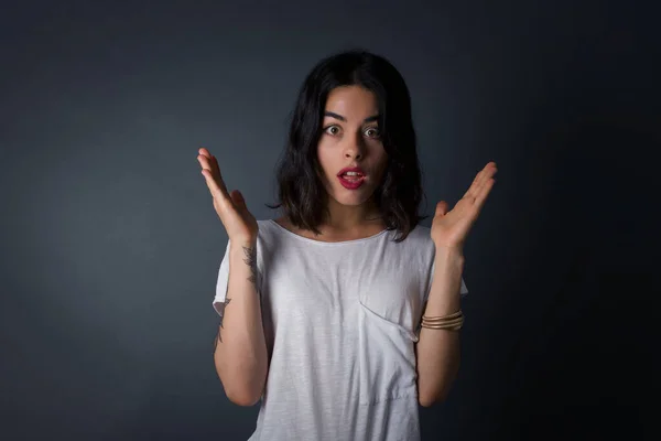 Surprise concept. Portrait of astonished beautiful girl looking surprised in full disbelief wide open mouth with hands near face with braided hair. Positive emotion facial expression body language.