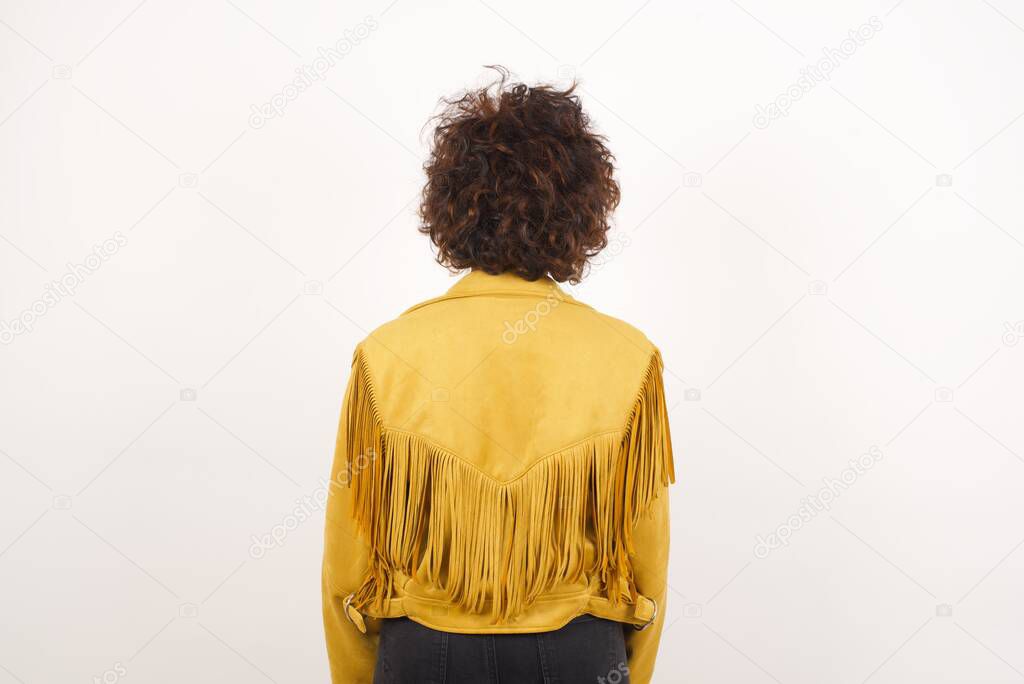 back view of woman in suede jacket  studio shot