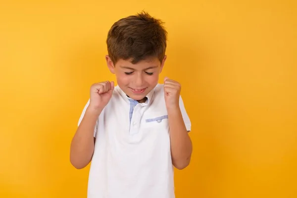 Schattig Jongen Houden Vuisten Tegen Gele Muur — Stockfoto