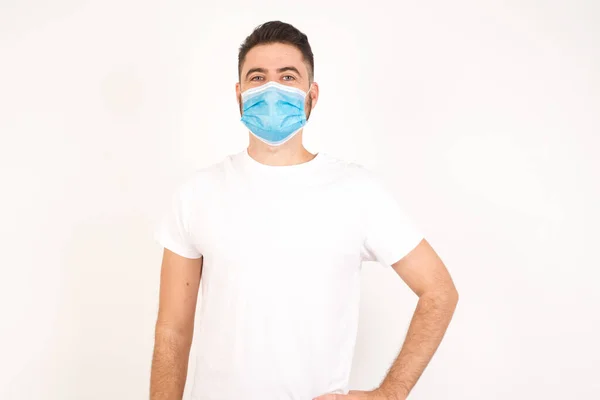 Studio Shot Cheerful Man Wearing Medical Mask Keeps Hand Hip — Stock Photo, Image