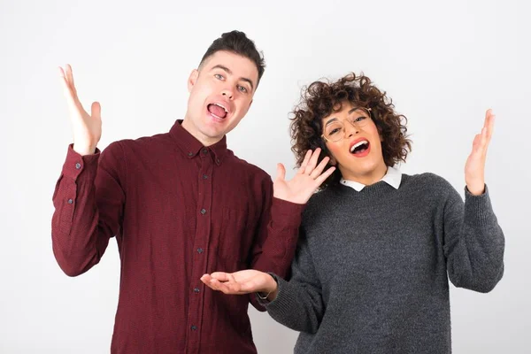 Cheerful Young Couple Making Welcome Gesture Raising Arms — Stock Photo, Image