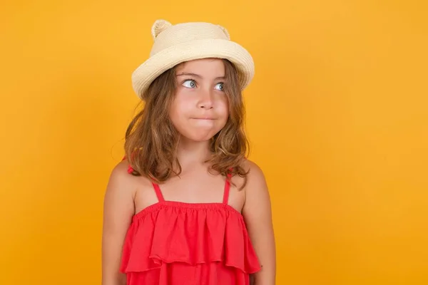 Cute Little Girl Wearing Red Dress Looking Away Yellow Background — Stock Photo, Image