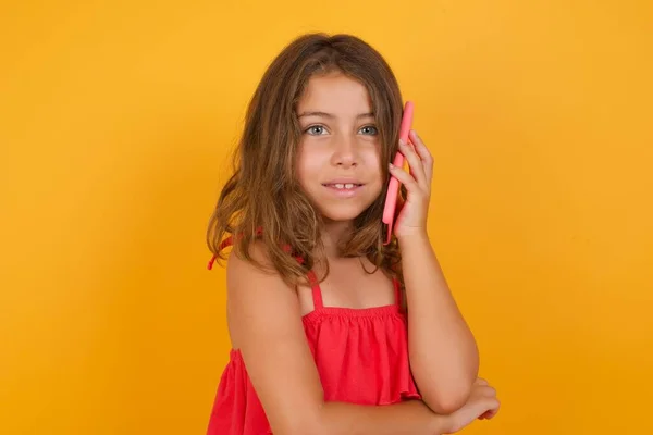 Beautiful Little Girl Wearing Red Dress Talking Smartphone Yellow Background — Stock Photo, Image