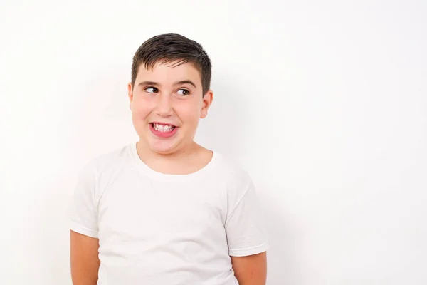 Portrait Boy Specific Appearance Clenches Teeth Looks Confusedly Aside Poses — Stock Photo, Image