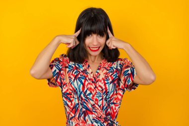 Genç güzel kız Concentrating sert bir fikirle ciddi bir göz alnına işaret her iki işaret parmakları ile düşünüyor