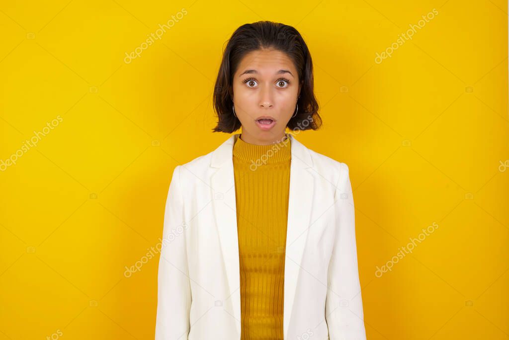 Attractive young woman having stunned and shocked look, with mouth open and jaw dropped, listening to friend's story in full disbelief, exclaiming: Wow, I can't believe this. Surprised girl. Shock