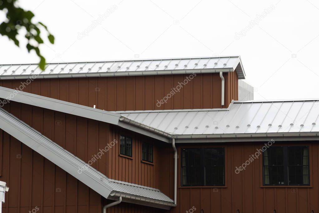 modern standig seam metal roof with roof window, fume hoods snow guard rain gutter