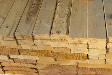 A stack of wood 2x4 beams, view of rough cut ends clipart