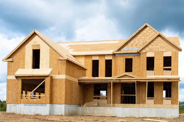 A single family home under construction the house has been framed and covered in plywood industry roof