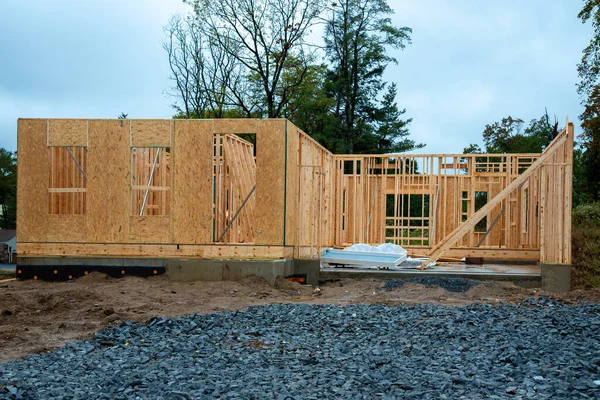 Interior of a new home construction showing the entire first floor plywood frame beam