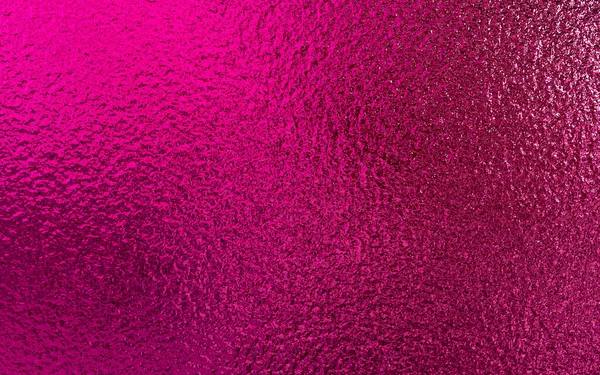 Pink metallic foil paper texture background.