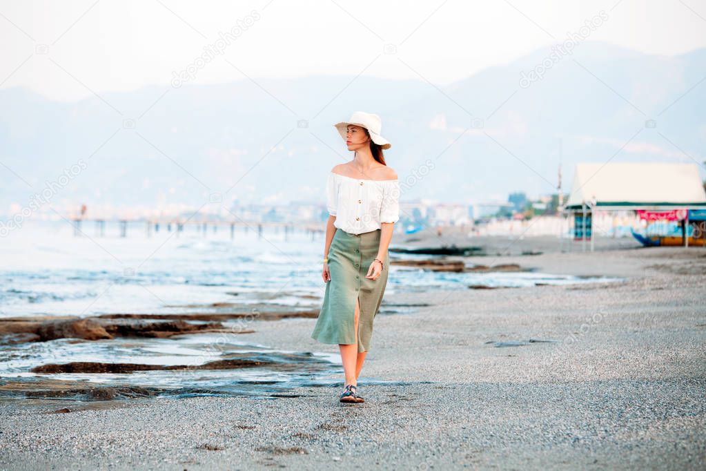 Lonley attractive woman walking at the beach
