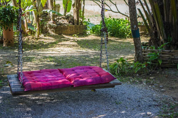 pink pad on wood swing