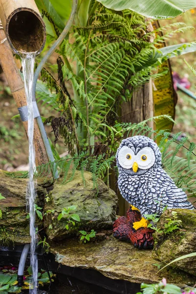 cute owl statue in garden